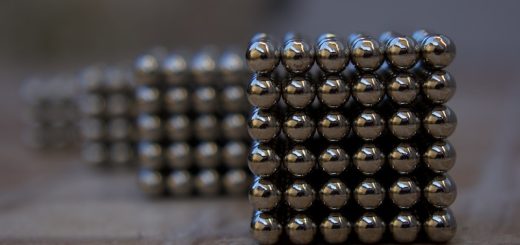 silver beads on brown wooden table