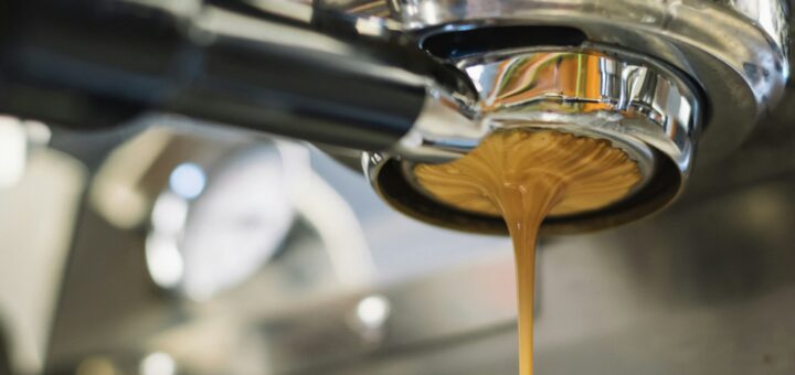 Latte dripping from a coffee machine